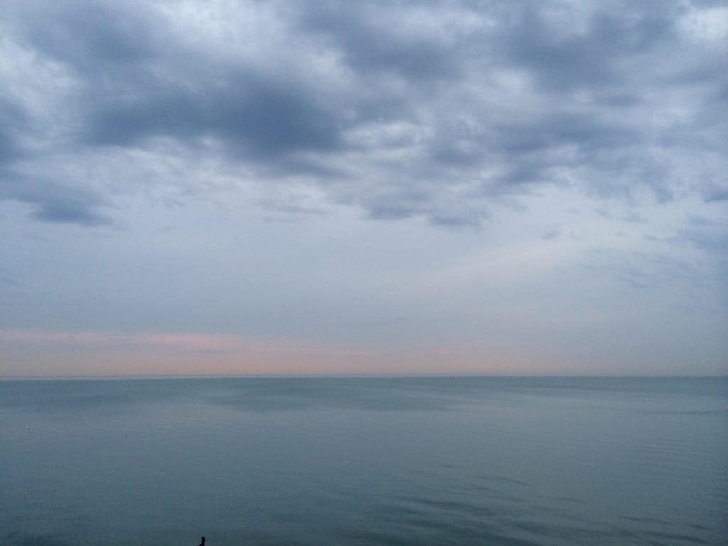 The sunrise over Lake Michigan. It's very serene and hazy